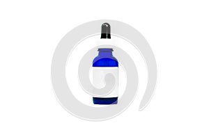 Blue glass eyedropper bottle isolated on white, with blank white label for adding your own text or logo. Bottle is transparent and