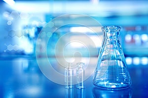 blue glass flask with vial in research chemistry science laboratory background