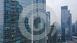 Blue glass modern skyscraper and office building in Jakarta. Glass modern fasade, reflection - Architecture in center