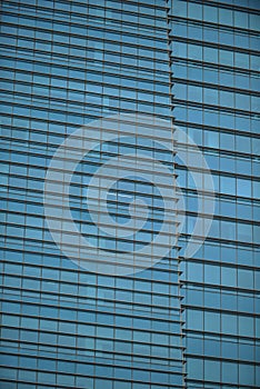 Blue glass skyscraper wall surface close up, financial city district