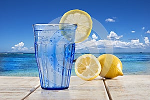 Blue glass with sparkling water and lemon