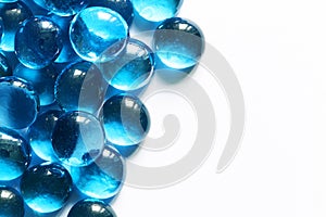 Blue glass spheres on white background. Closeup macro abstract