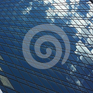 Blue glass surfaces and the sky reflected in them