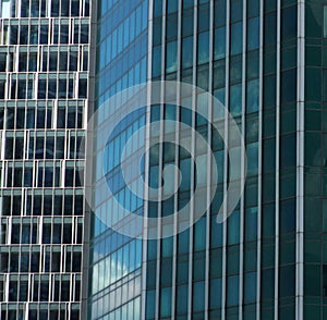 Blue glass surfaces and the sky reflected in them