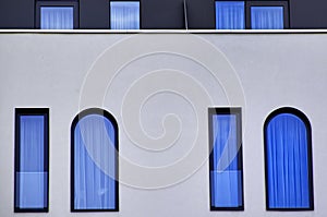 Blue glass windows on a modern building wall