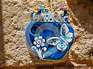 blue glazed ceramic ornament flower pot turkish souvenir on stone wall, Side