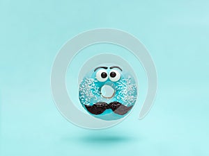 Blue glazed donut with mustache flying