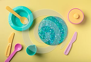 blue glitter slime and kitchen utensil toys
