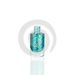 Blue glittering nail polish glass bottle on white background isolated close up, opened green sequin varnish, turquoise lacquer