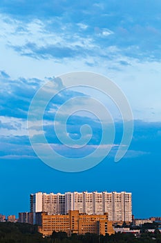 Blue gloaming sky over urban house in summer