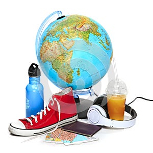 The blue globe, sneakers, thermos and headphones on white background.