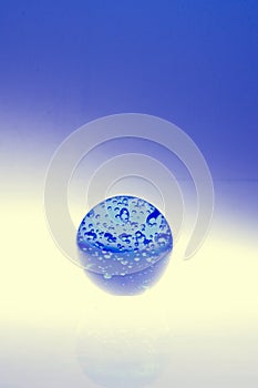 Blue globe with water drops