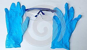 Blue gloves adjusting safety glasses