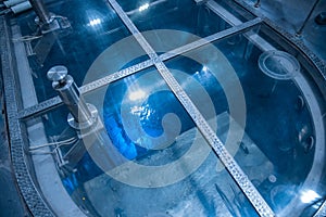Blue glow water of nuclear reactor core powered, caused by Cherenkov radiation, fuel plates industrial uran