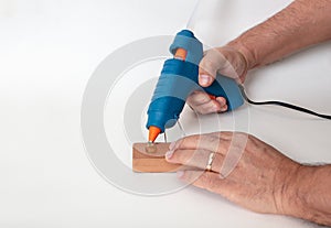 Blue glue gun in a man hand