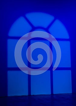 Blue gobo window light pattern on wall