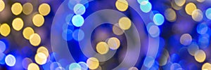 Blue and gold bokeh holidays lights at night, christmas and new year party panoramic web banner