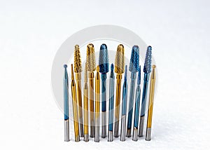 Blue and gold Dental drill with nano coating isolated on white background. Carbide burs - Dental equipment