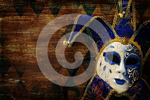 blue with gold elegant traditional venetian mask over dark background.