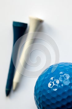 Blue golf ball - tees on background