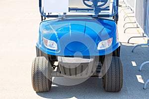 Blue golf car front and headlights, bumper