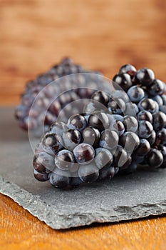 Blue grape clusters on slate board