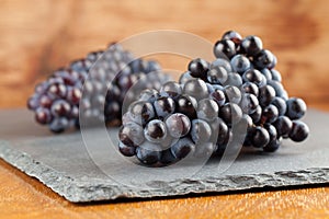 Blue grape clusters on slate board