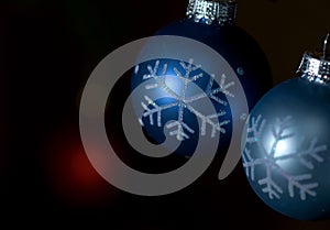 Blue and gray ornaments against dark background
