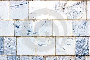 Blue and gray vintage marble ceramic tile textured background on the old building stone brick wall close up.