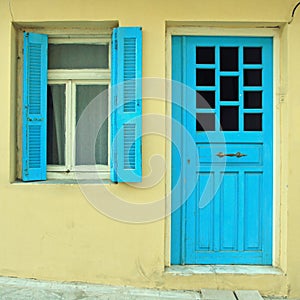 Blue greek shutters window and door in old house
