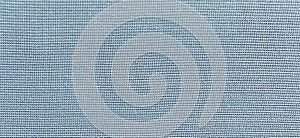 Blue-green background of intertwined threads and rows. Banner. Fabric texture with uneven surface