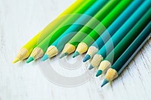 Blue and Green Colored Pencils in a Row
