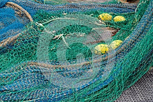 Blue and green fishing nets in a harbour