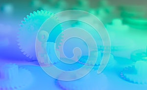 Blue and green gears on the colorful background - compilation, concept, abstract.