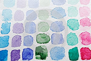 Blue, green, pink and lilac stains of watercolor paint