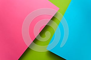 Blue, green and pink pastel colored paper background. Volume geometric flat lay