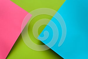 Blue, green and pink pastel colored paper background. Volume geometric flat lay. Top view.