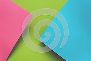 Blue, green and pink pastel colored paper background. Volume geometric flat lay. Top view. Copy space. Toned