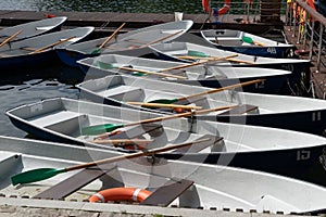 Blue -Green pleasure boats moored at the pier in the Park. Summer skiing on the lake in the Park. Outdoor recreation with family