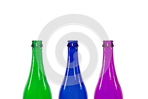 Blue green and purple colored glass bottles, isolated on white background
