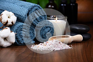 Blue-green towels, salt and candle on wooden background spa still life stock photo images
