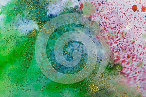 Blue-green watercolor stains with sparkles. Abstract background