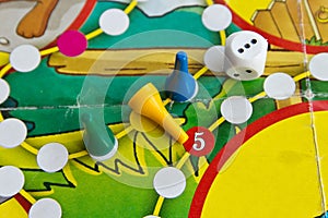 Blue, green and yellow plastic chips and dice in old Board games for children
