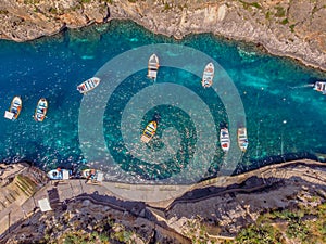 Blue Grotto in Malta. Pleasure boat with tourists runs. Aerial top view