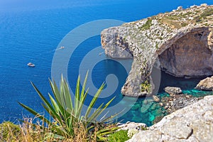 Blue Grotto rock cliff arch in Malta, aerial view from the Mediterranean Sea to the island