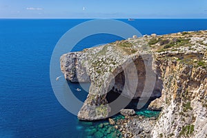 Blue Grotto rock cliff arch in Malta, aerial view from the Mediterranean Sea to the island