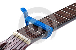 Blue guitar capo and guitar isolated on white background