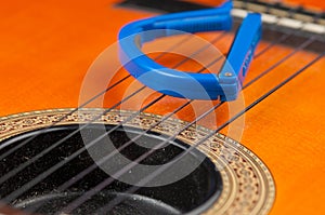 Blue guitar capo and guitar isolated on white background