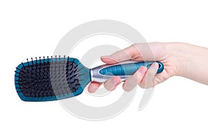 Blue hair brush in hand