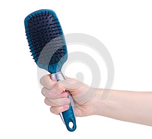 Blue hair brush in hand